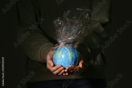 Woman with model of Earth i...