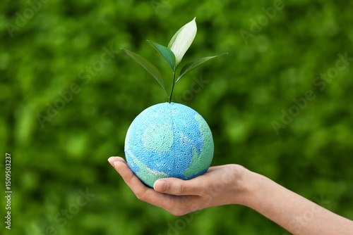 Female hand with sprout and...