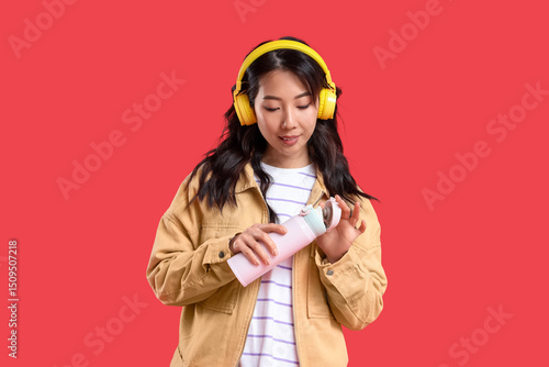 Young Asian woman in headph...