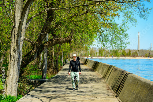 Wallpaper Mural Healthy active outdoor lifestyle: senior man hat sunglasses beard walking on a wooden boardfwalk in sunshine on the Toronto Islands shot in spring	
 Torontodigital.ca