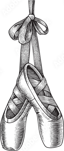 Elegant ballet slippers hang suspended from a satin ribbon.