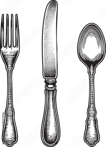 Three silver cutlery items stand upright against a white background.
