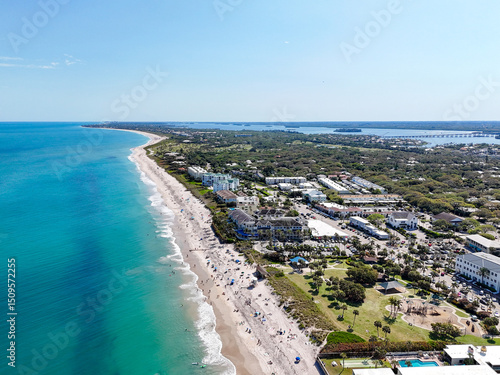 Aerial view along the coastline on a beautiful sunny summer beach day in Vero Beach located in Indian River County, Florida.