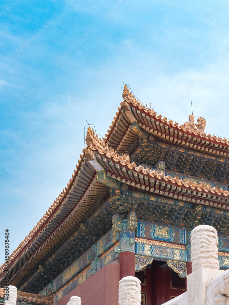 Ornate Chinese imperial palace roof with yellow glazed tiles and intricate painted dougong brackets. Detail of Forbidden City (Palace Museum), Beijing, China. Ornate Chinese imperial palace roof with yellow glazed tiles and intricate painted dougong brackets. Detail of Forbidden City (Palace Museum), Beijing, China.