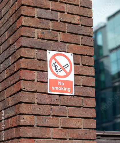 No Smoking Sign on Brick Wall in London