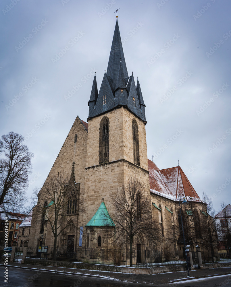 Church with a tall steeple under a cloudy sky Church with a tall steeple under a cloudy sky