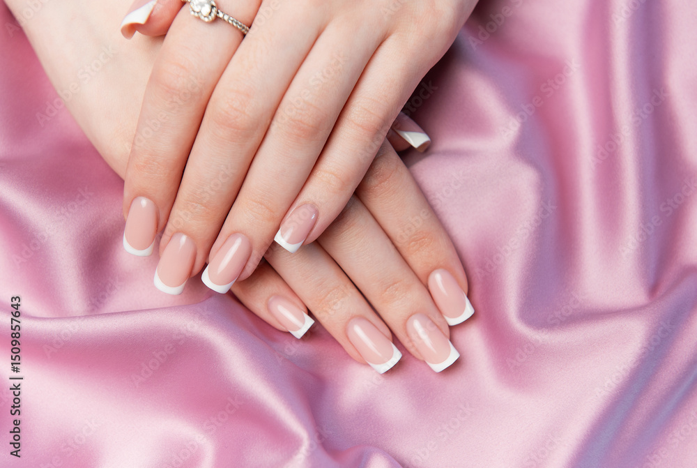 Fototapeta premium Woman showing french manicure on pink satin background