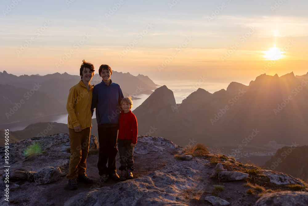 Fototapeta premium Children and adults, family with dog, hiking Grytetippen trail in Senja, Lofoten on a sunny hot summer day