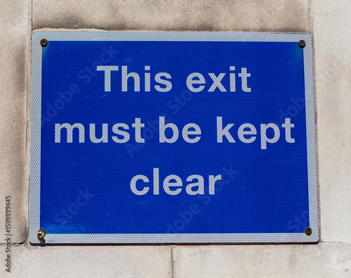 Blue Warning Sign on Wall