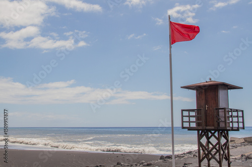Red flag at the beach of puerto de Tazacorte, La Palma, Canary Islands (swimming not allowed)
