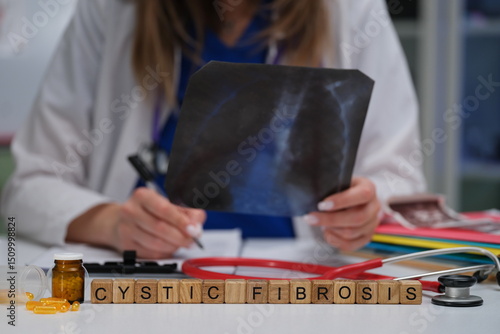 A qualified healthcare professional carefully examines an Xray image related to the treatment of cystic fibrosis