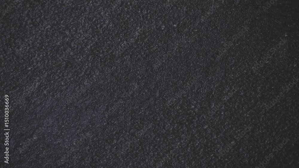 Heavy rain falls on asphalt in slow motion. Evening time and large raindrops. Heavy rain falls on asphalt in slow motion. Evening time and large raindrops.