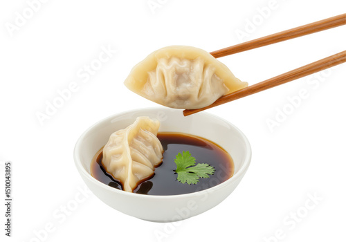 Fotografie Isolated Steamed Dumpling Held by Chopsticks Dipped in Soy Sauce