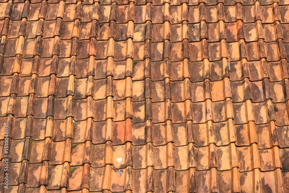 Old textured terracotta roof tiles with natural weather stains and rustic patterns. Old textured terracotta roof tiles with natural weather stains and rustic patterns.