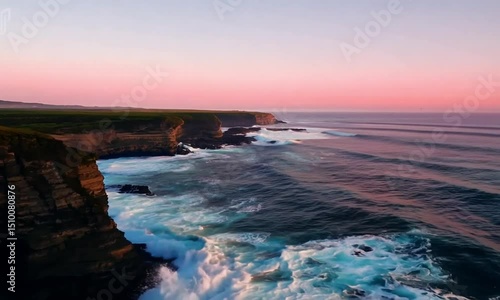 Wallpaper Mural Create a high-resolution drone video soaring above a coastline where waves crash rhythmically against rugged cliffs, as seagulls glide through the misty sea air under a glowing pink and orange dusk Torontodigital.ca