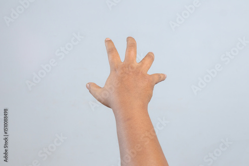 Outstretched human hand with spread fingers reaching forward showing gesture of interaction or motion against minimal background