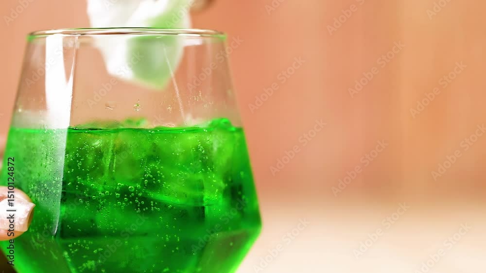 Hand Wiping Green Drink in Glass Hand Wiping Green Drink in Glass