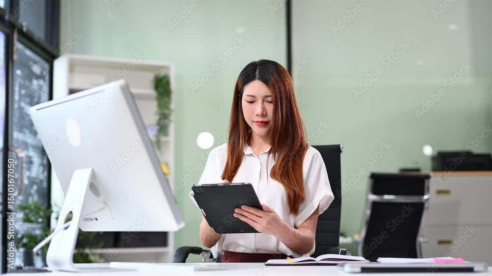 Business woman using tablet and laptop for doing math finance on an office desk, tax, report, accounting, statistics, and analytical research concept Business woman using tablet and laptop for doing math finance on an office desk, tax, report, accounting, statistics, and analytical research concept