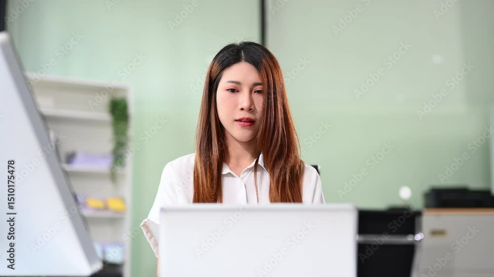 Asian businesswoman working with working notepad, tablet and laptop documents in the office Asian businesswoman working with working notepad, tablet and laptop documents in the office