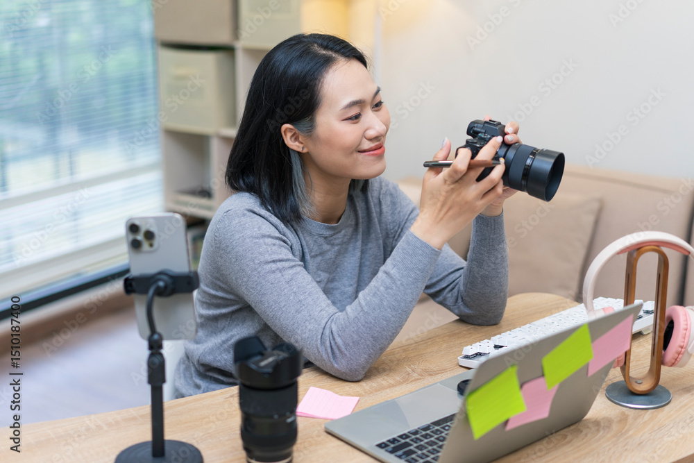 Woman with camera enjoying creative work at home office desk with various equipment and natural light from window Woman with camera enjoying creative work at home office desk with various equipment and natural light from window