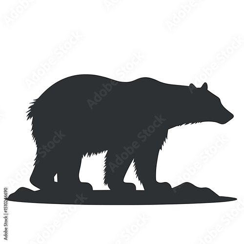 Silhouette of a bear standing on rocky ground in profile view  