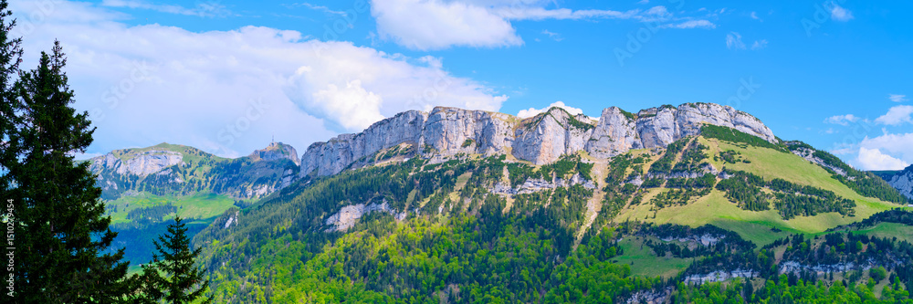 Breathtaking mountain landscape showcasing cliffs and lush greenery in a sunny afternoon Breathtaking mountain landscape showcasing cliffs and lush greenery in a sunny afternoon