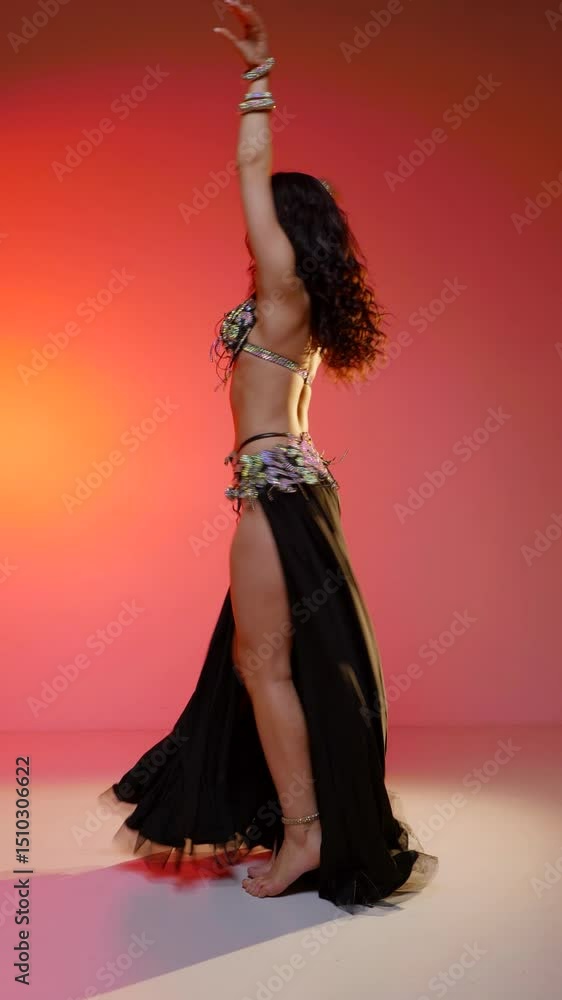 Vertical. Beautiful young woman dancing belly dance. Silhouette of a female dancer. Oriental belly dance.
Vertical. Beautiful young woman dancing belly dance. Silhouette of a female dancer. Oriental belly dance.