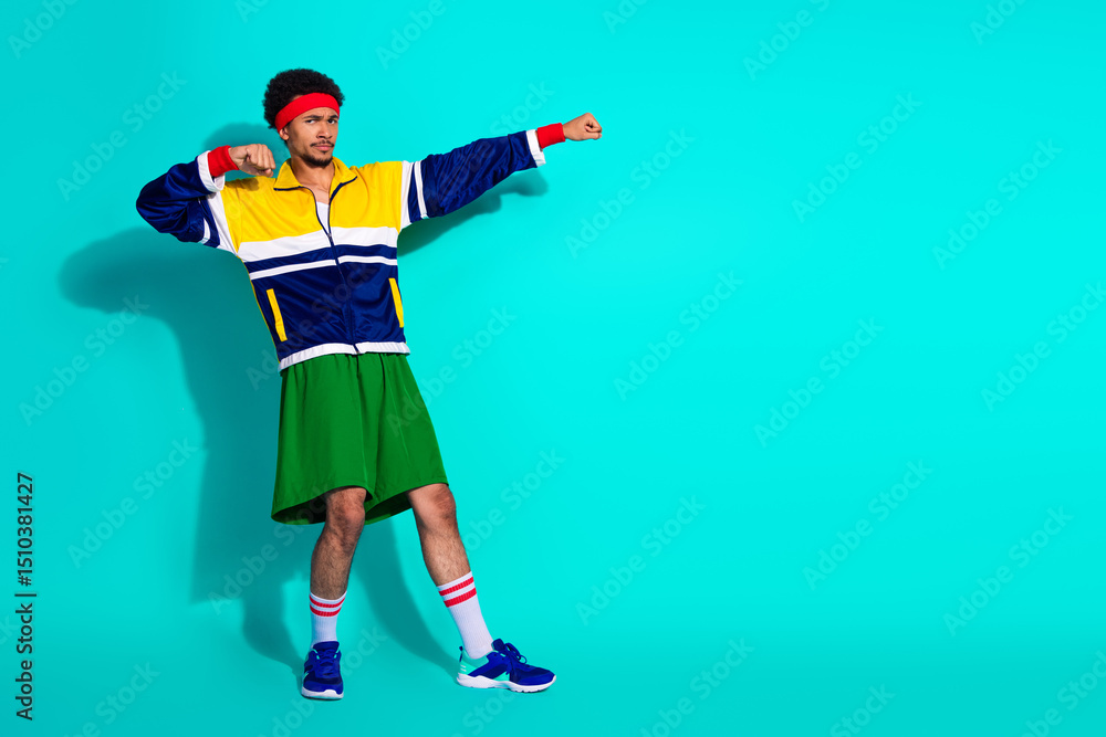 Young athlete in vibrant retro sportswear posing dynamically on a bright teal background, showcasing vintage style, activewear fashion Young athlete in vibrant retro sportswear posing dynamically on a bright teal background, showcasing vintage style, activewear fashion