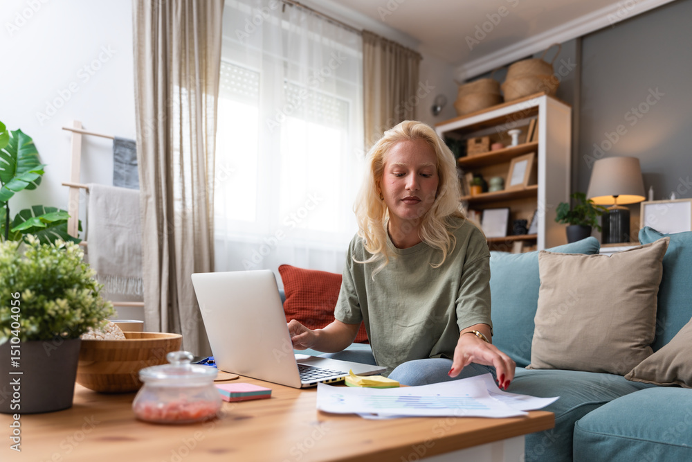 Young woman freelance worker small startup company business owner calculating tax return with data on laptop computer. Working at home office, professional occupation female modern technology user. Young woman freelance worker small startup company business owner calculating tax return with data on laptop computer. Working at home office, professional occupation female modern technology user.