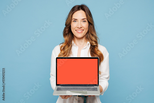 Φωτογραφία Young employee IT business woman corporate lawyer wears shirt classic formal clothes work in office hold use showing blank screen area laptop pc computer isolated on blue background studio portrait