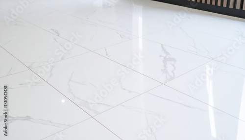 Glossy white marble floor tiles with subtle veining and dark trim detail © lalala