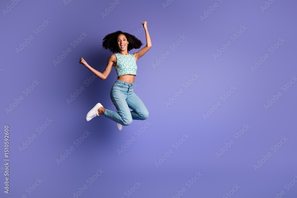 Joyful afro-american woman jumping against violet background with happiness and freedom Joyful afro-american woman jumping against violet background with happiness and freedom