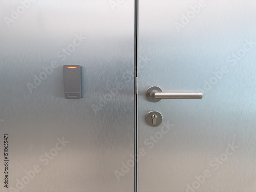 Closed metal office door with smart card reader and secure handle. Symbol of corporate access control, staff only zones, modern building security and workplace infrastructure