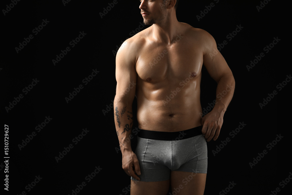 Fototapeta premium Young man in stylish light grey underwear on black background, closeup