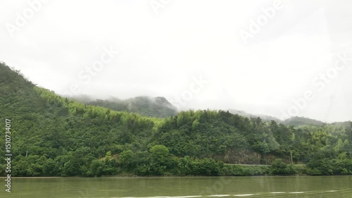 The natural scenery and various boats on the Fuchun River in Tonglu, Hangzhou, Zhejiang, China. High quality 4k footage