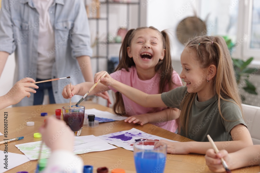Fototapeta premium Kids with teacher at painting lesson indoors. Learning to draw