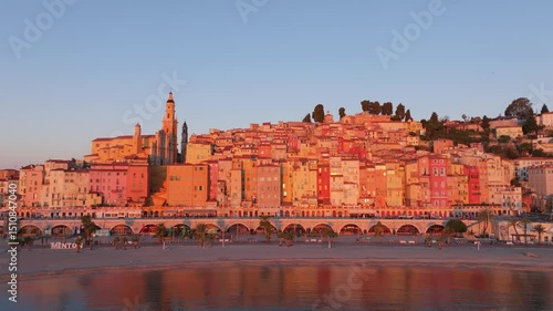 French Riviera town of Menton glows in morning light, France. Aerial drone video