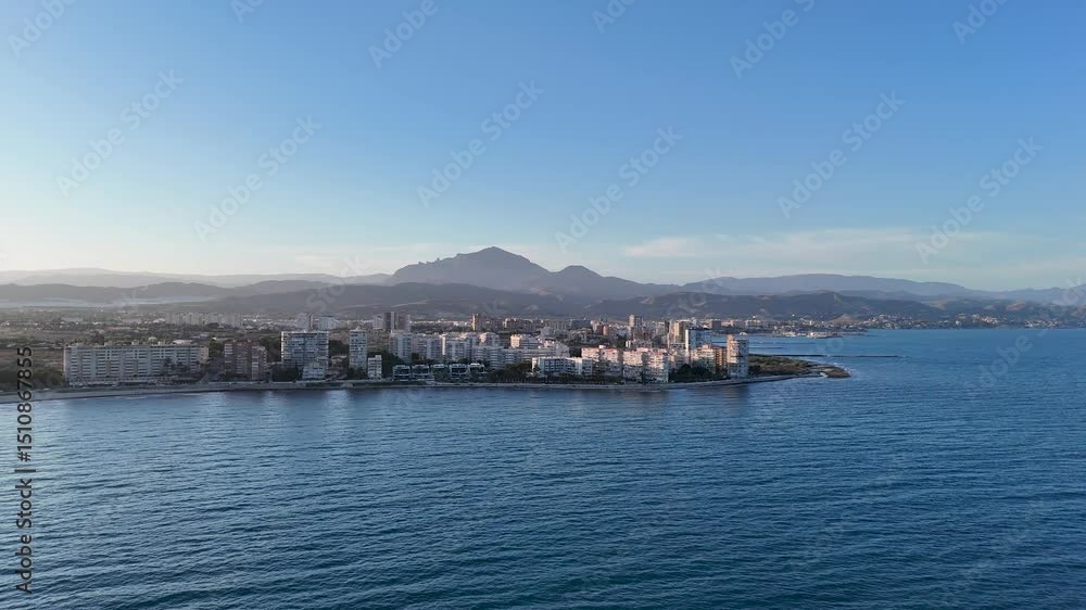 Panoramic view of a Spanish coastal town with mountains and the Mediterranean Sea. Alicante , San Juan , Campello Costa Blanca Panoramic view of a Spanish coastal town with mountains and the Mediterranean Sea. Alicante , San Juan , Campello Costa Blanca