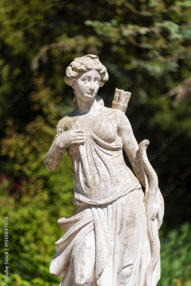 Statue de Diane en pierre dans le jardin d'un manoir Statue de Diane en pierre dans le jardin d'un manoir