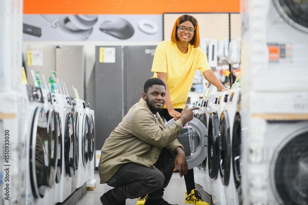 African american Couple choosing washing machine, electronics store. African american Couple choosing washing machine, electronics store.