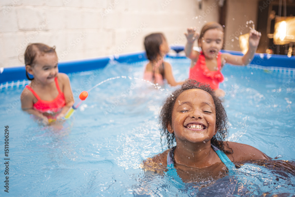 Children enjoying playtime in a backyard pool on a sunny afternoon Children enjoying playtime in a backyard pool on a sunny afternoon