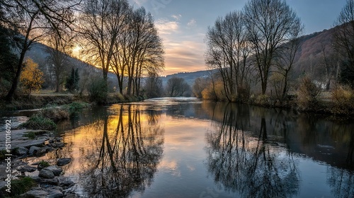 Wallpaper Mural   A serene body of water enveloped by lush trees, bathed in a mesmerizing sunset, and framed majestically by distant mountains Torontodigital.ca