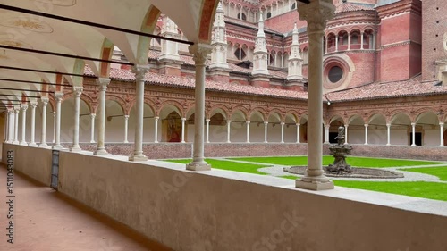 Cloister of the Charterhouse of Pavia, Italy, featuring Renaissance arcades, frescoed ceilings, a central fountain, and detailed Gothic-Renaissance architecture