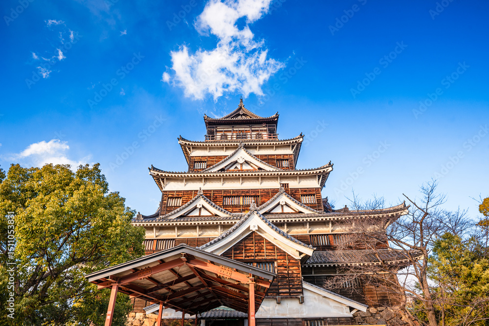 Hiroshima Castle main tower in yellow autumnal leaves, Hiroshima, Japan Hiroshima Castle main tower in yellow autumnal leaves, Hiroshima, Japan