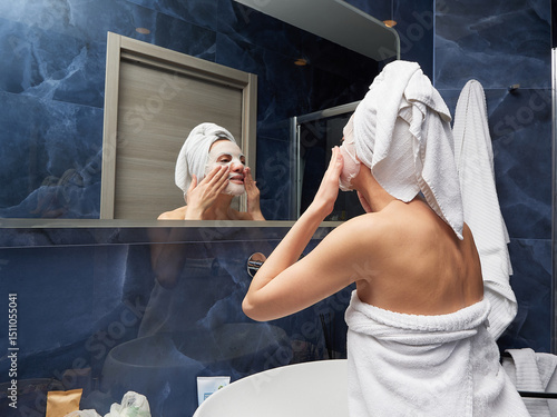 Woman put face mask at bathroom