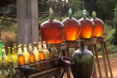 Sale on the black market of smuggled petrol in glass container on the edge of a road, Benin, Africa
