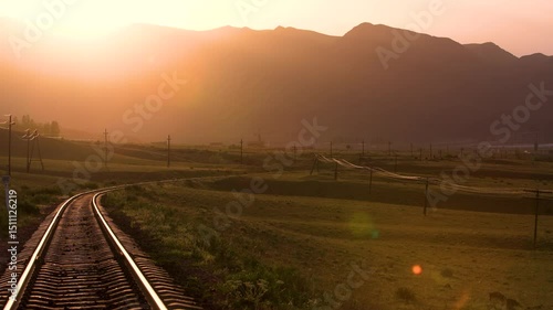 Railroad in the mountains at warm sunset light