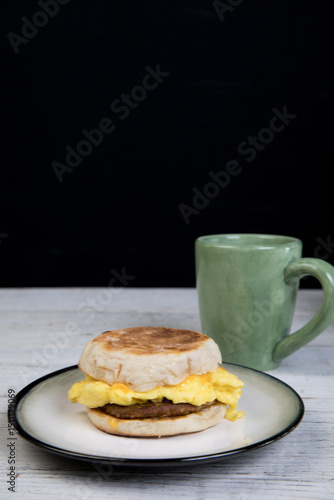 English muffin breakfast sandwich with coffee 