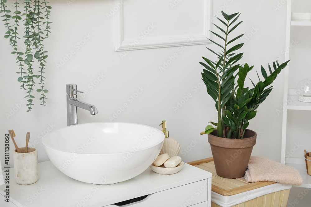 Fototapeta premium Sink bowl and cup with toothbrushes on chest of drawers in bathroom, closeup