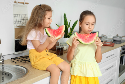 Two young girls eating fres...